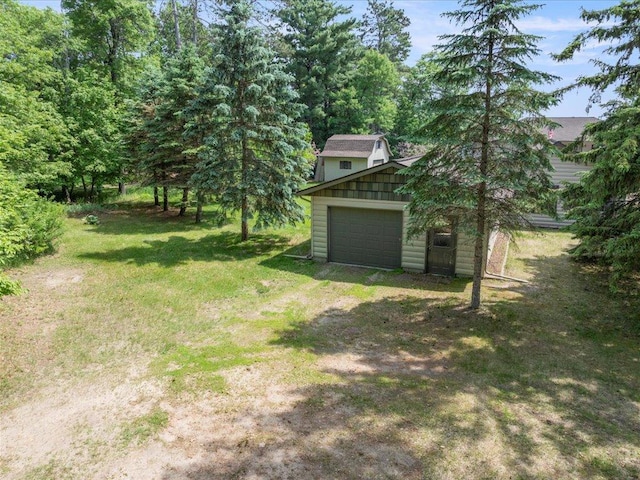 9174 Aloha Ln, Pelican Twp, MN 56472 - view of grassy yard with an outbuilding, dirt driveway, and a garage