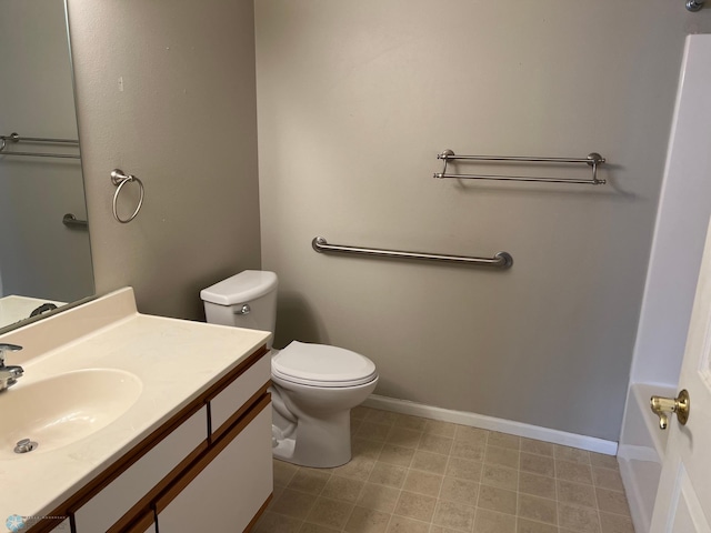 358 30th St N, Moorhead, MN 56560 - bathroom with toilet, vanity, baseboards, and tile patterned floors