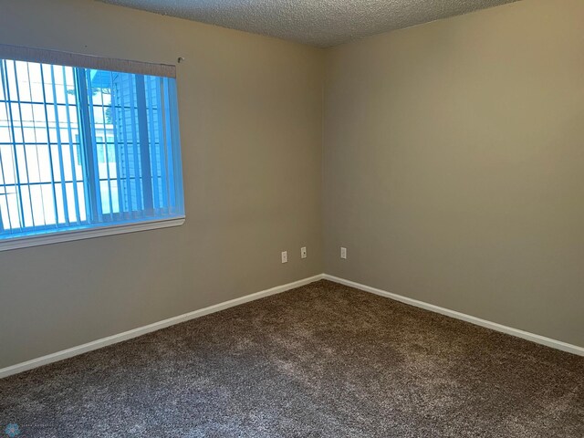358 30th St N, Moorhead, MN 56560 - carpeted empty room with a textured ceiling and baseboards