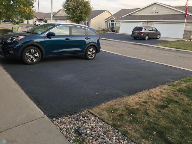 358 30th St N, Moorhead, MN 56560 - view of car parking with asphalt driveway and an attached garage