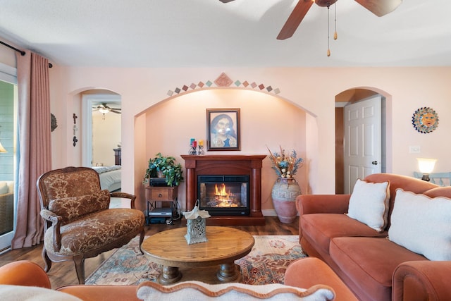 2146 84th Ave, Osceola, WI 54020 - living area with a ceiling fan, a glass covered fireplace, wood finished floors, and arched walkways