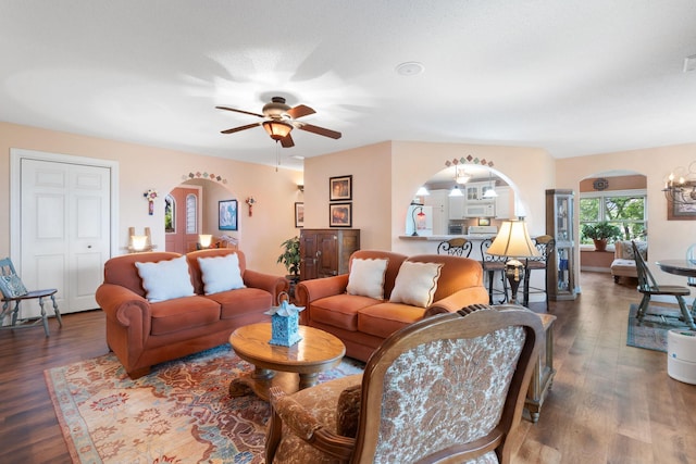2146 84th Ave, Osceola, WI 54020 - living area with arched walkways, wood finished floors, a ceiling fan, and a chandelier