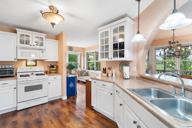 2146 84th Ave, Osceola, WI 54020 - kitchen with white appliances, a sink, a chandelier, dark wood-style flooring, and white cabinetry