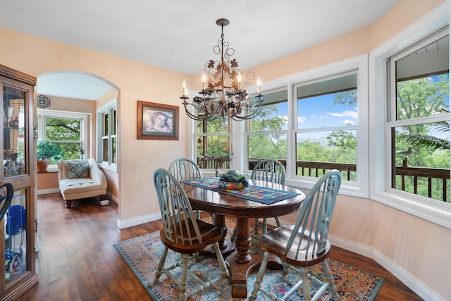 2146 84th Ave, Osceola, WI 54020 - dining room with arched walkways, baseboards, dark wood-style floors, and a chandelier