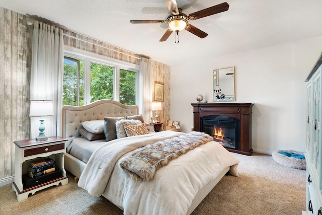 2146 84th Ave, Osceola, WI 54020 - carpeted bedroom with a glass covered fireplace, ceiling fan, and baseboards