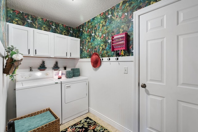 2146 84th Ave, Osceola, WI 54020 - laundry area with wallpapered walls, washing machine and dryer, cabinet space, a textured ceiling, and baseboards