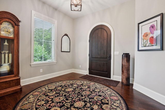749 Fairway Dr, Medina, MN 55340 - foyer featuring wood finished floors, arched walkways, and baseboards