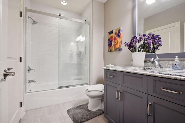 749 Fairway Dr, Medina, MN 55340 - bathroom featuring vanity, toilet, and bath / shower combo with glass door