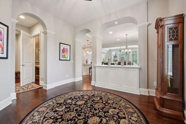749 Fairway Dr, Medina, MN 55340 - foyer with dark wood-style floors, ornate columns, arched walkways, baseboards, and recessed lighting