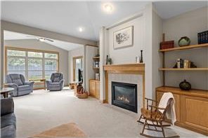 14457 Freesia Way, Apple Valley, MN 55124 - living area with a glass covered fireplace, lofted ceiling, and carpet flooring