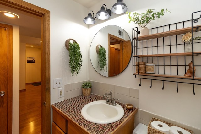 1269 Cleveland Ave N Unit 2B, Saint Paul, MN 55108 - bathroom with wood finished floors, vanity, and decorative backsplash