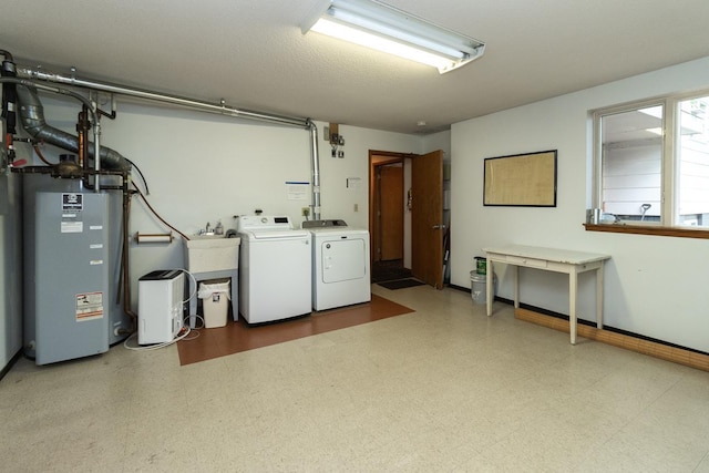 1269 Cleveland Ave N Unit 2B, Saint Paul, MN 55108 - washroom with washing machine and clothes dryer, light flooring, a sink, and baseboards