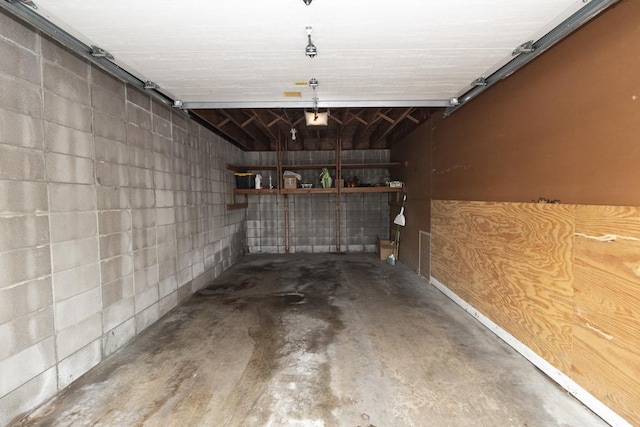 1269 Cleveland Ave N Unit 2B, Saint Paul, MN 55108 - garage featuring concrete block wall and a garage door opener