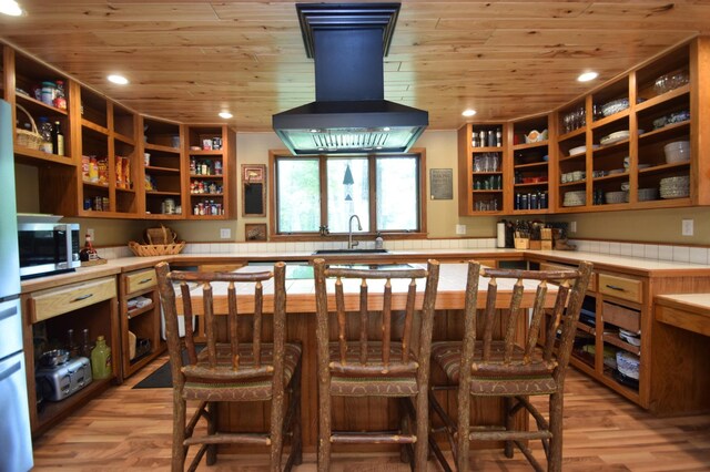 27625 Clear Sky Rd, Jackson Twp, WI 54893 - kitchen featuring wall chimney range hood, a sink, wooden ceiling, open shelves, and stainless steel microwave