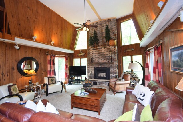 27625 Clear Sky Rd, Jackson Twp, WI 54893 - living room featuring wooden walls, high vaulted ceiling, a ceiling fan, healthy amount of natural light, and carpet floors