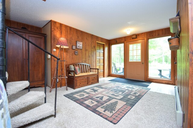 27625 Clear Sky Rd, Jackson Twp, WI 54893 - carpeted foyer featuring wooden walls, stairway, and a baseboard heating unit