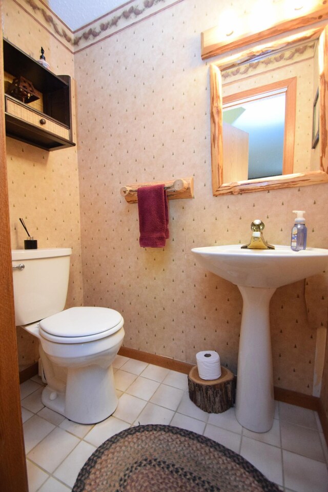27625 Clear Sky Rd, Jackson Twp, WI 54893 - bathroom with toilet, tile patterned flooring, baseboards, and a sink