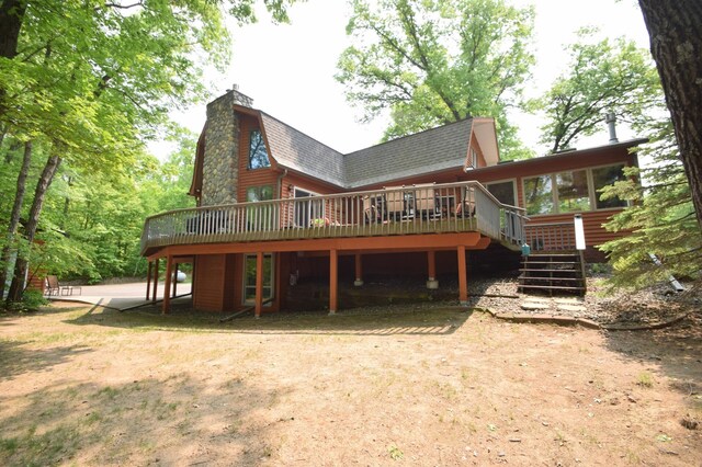27625 Clear Sky Rd, Jackson Twp, WI 54893 - back of property with a deck, a chimney, roof with shingles, stairway, and a gambrel roof