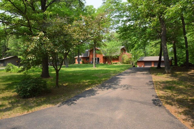 27625 Clear Sky Rd, Jackson Twp, WI 54893 - view of front of house featuring a front lawn, an outbuilding, a garage, and a barn