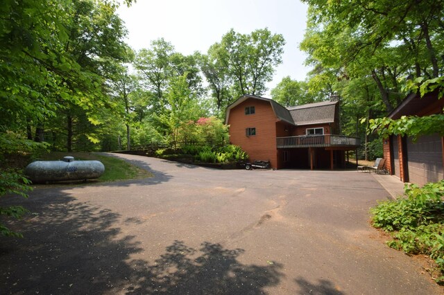 27625 Clear Sky Rd, Jackson Twp, WI 54893 - view of front of property with a gambrel roof, a deck, and a chimney