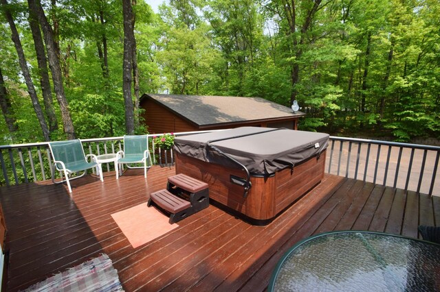 27625 Clear Sky Rd, Jackson Twp, WI 54893 - wooden deck with a hot tub and a wooded view