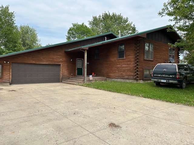 140 Northern Ave NW, Blackduck, MN 56630 - log home with an attached garage, board and batten siding, driveway, and log siding