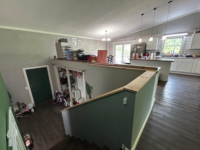 140 Northern Ave NW, Blackduck, MN 56630 - kitchen featuring stainless steel refrigerator with ice dispenser, vaulted ceiling, dark wood finished floors, a textured ceiling, and a chandelier