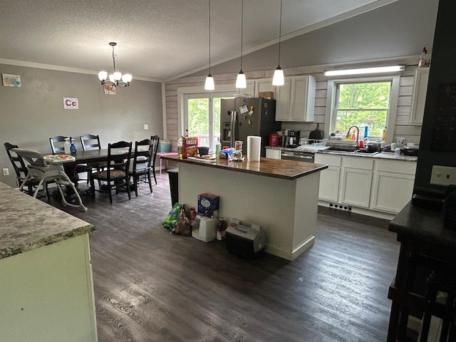 140 Northern Ave NW, Blackduck, MN 56630 - kitchen with appliances with stainless steel finishes, vaulted ceiling, a chandelier, crown molding, and white cabinetry