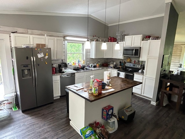 140 Northern Ave NW, Blackduck, MN 56630 - kitchen with stainless steel appliances, lofted ceiling, butcher block countertops, dark wood finished floors, and white cabinets