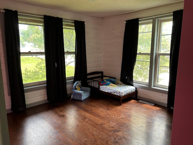 140 Northern Ave NW, Blackduck, MN 56630 - bedroom featuring wood-type flooring, a textured ceiling, and multiple windows