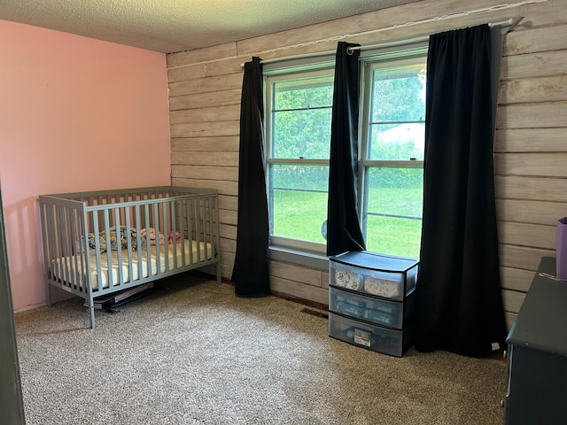 140 Northern Ave NW, Blackduck, MN 56630 - carpeted bedroom with wooden walls and a textured ceiling