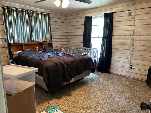 140 Northern Ave NW, Blackduck, MN 56630 - bedroom featuring wooden walls, a textured ceiling, carpet, and ceiling fan