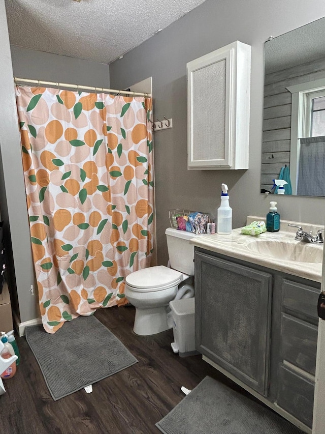 140 Northern Ave NW, Blackduck, MN 56630 - bathroom with vanity, wood finished floors, a textured ceiling, and a shower with shower curtain
