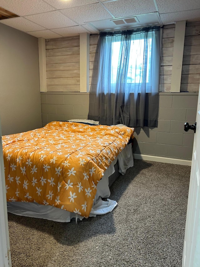140 Northern Ave NW, Blackduck, MN 56630 - bedroom featuring concrete block wall, a paneled ceiling, and carpet flooring