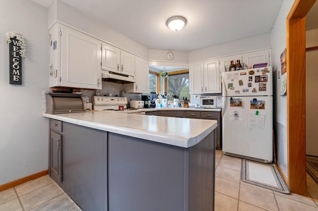 1609 Doddridge Ave, Cloquet, MN 55720 - kitchen featuring white appliances, a peninsula, light countertops, white cabinets, and under cabinet range hood
