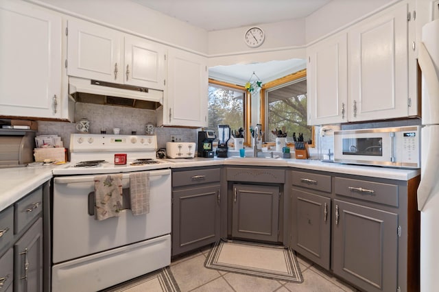1609 Doddridge Ave, Cloquet, MN 55720 - kitchen featuring white appliances, gray cabinets, under cabinet range hood, white cabinetry, and a sink