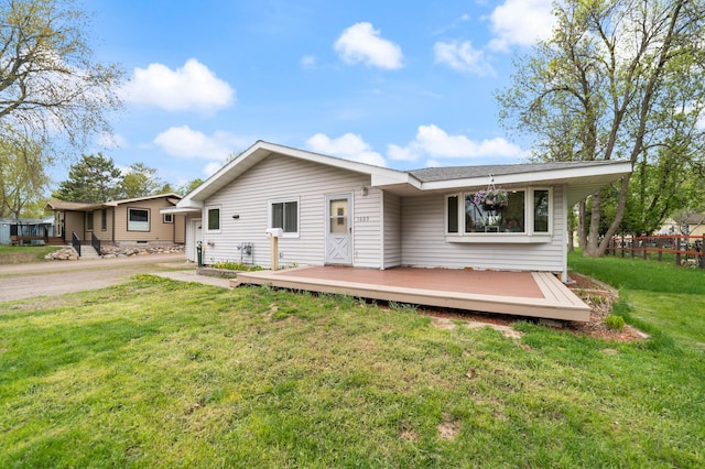 1609 Doddridge Ave, Cloquet, MN 55720 - back of property with a lawn and a wooden deck