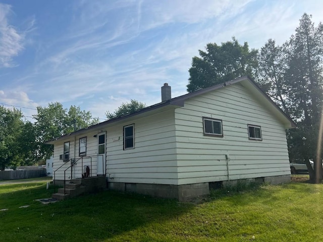 312 1st St NE, Sebeka, MN 56477 - rear view of house with a lawn, a chimney, cooling unit, and crawl space