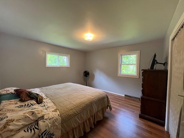 312 1st St NE, Sebeka, MN 56477 - bedroom featuring multiple windows, wood finished floors, and baseboards