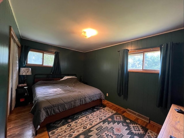 312 1st St NE, Sebeka, MN 56477 - bedroom featuring wood finished floors, baseboards, and wooden walls