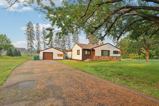 5963 Viking Blvd, Wyoming, MN 55092 - single story home featuring a detached garage, driveway, an outbuilding, a front yard, and a chimney
