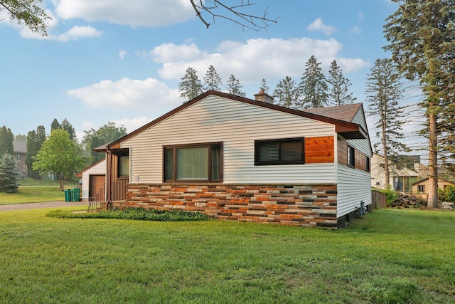 5963 Viking Blvd, Wyoming, MN 55092 - view of side of property with a yard, a garage, a chimney, and roof with shingles