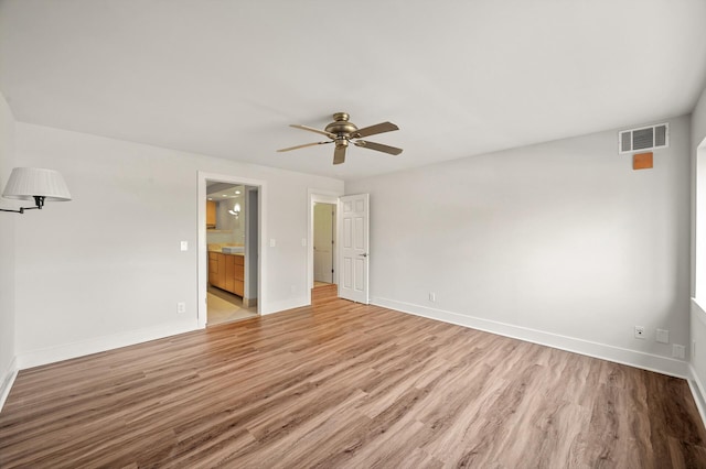2885 Knox Ave S Unit 202, Minneapolis, MN 55408 - unfurnished bedroom featuring light wood-style floors, baseboards, ensuite bath, and ceiling fan