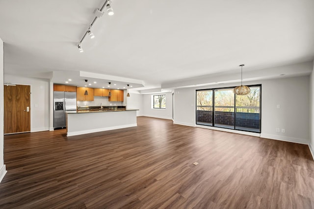 2885 Knox Ave S Unit 202, Minneapolis, MN 55408 - unfurnished living room featuring rail lighting, dark wood finished floors, baseboards, recessed lighting, and a sink