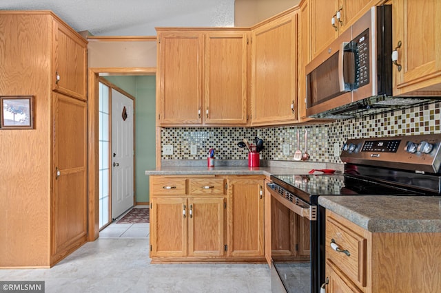 914 106th Ave NW, Coon Rapids, MN 55433 - kitchen featuring black / electric stove, stainless steel microwave, lofted ceiling, backsplash, and light tile patterned floors