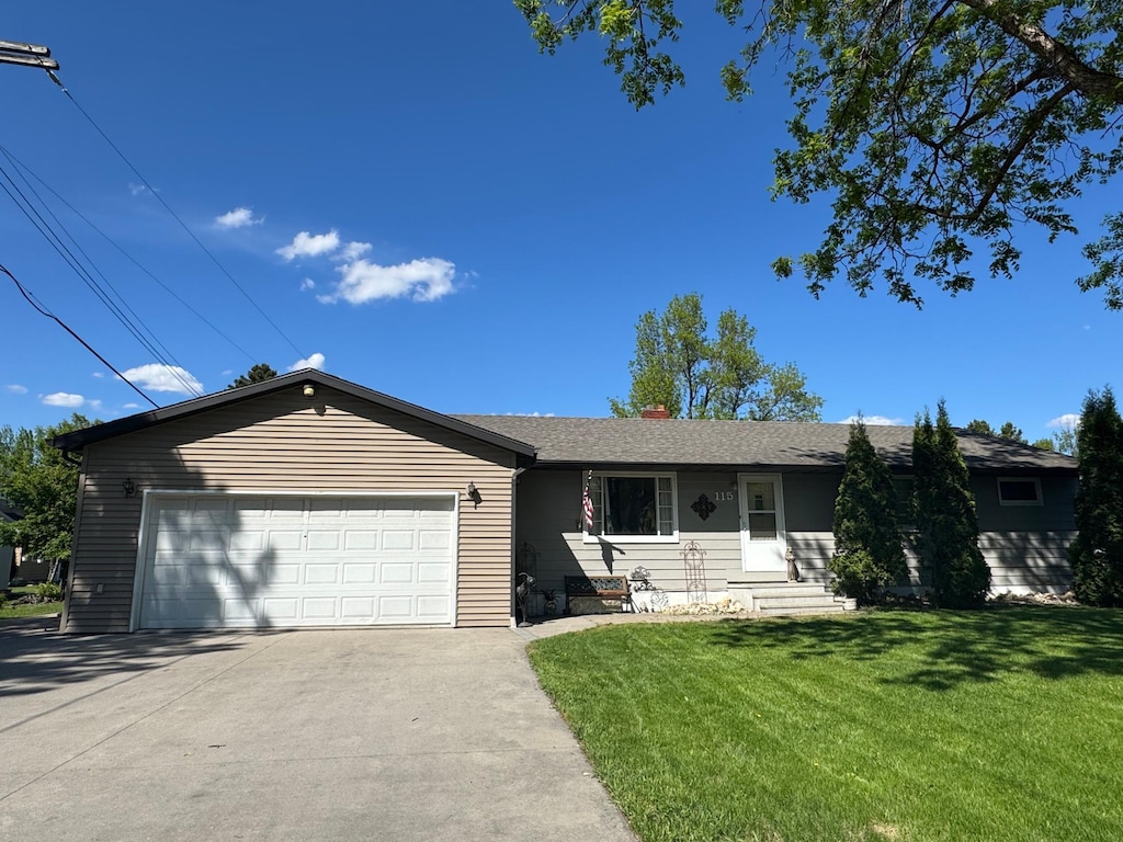 115 7th Ave S, Crookston, MN 56716 - ranch-style home featuring concrete driveway, a front lawn, and an attached garage
