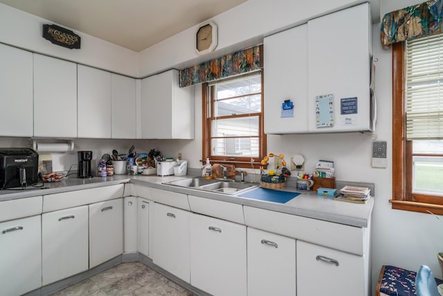 115 7th Ave S, Crookston, MN 56716 - kitchen featuring light countertops, white cabinets, and healthy amount of natural light