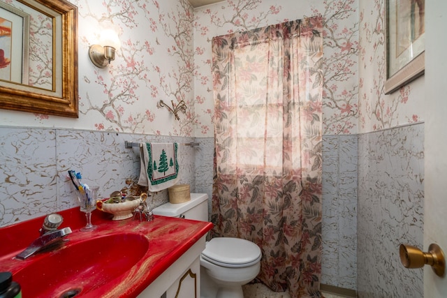 115 7th Ave S, Crookston, MN 56716 - bathroom featuring wallpapered walls, wainscoting, vanity, and tile walls
