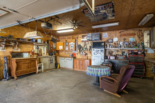 115 7th Ave S, Crookston, MN 56716 - garage with a workshop area, a garage door opener, and ceiling fan