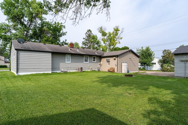 115 7th Ave S, Crookston, MN 56716 - back of property featuring a lawn and a chimney